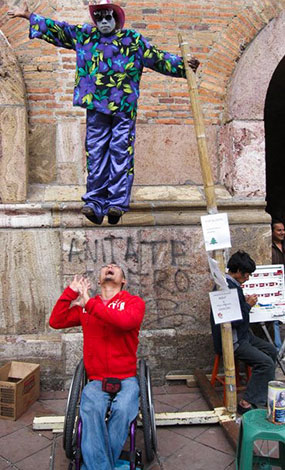 Matt Getze posing under street performer in the city center in Cuenca, Ecuador